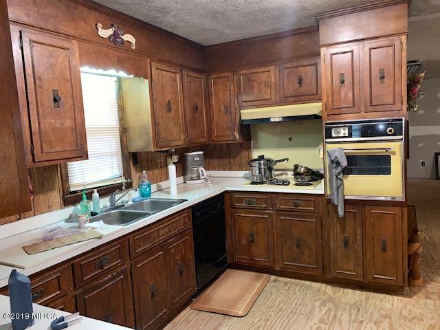 3229 Hamlin Road Lizella, GA 31052 - Photo 8 of 23 a kitchen with stainless steel appliances granite countertop a sink stove and cabinets