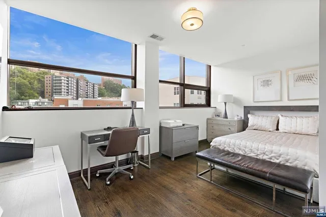 a bedroom with a bed window and a desk