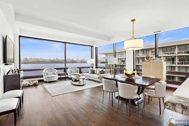 a view of a dining room with furniture a chandelier and wooden floor