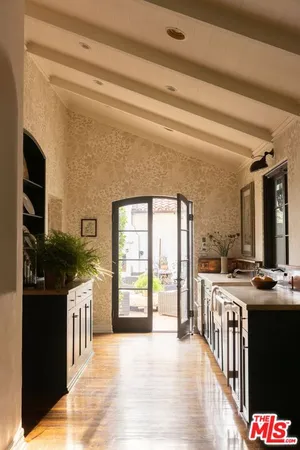 a view of a glass door with a tree in the background