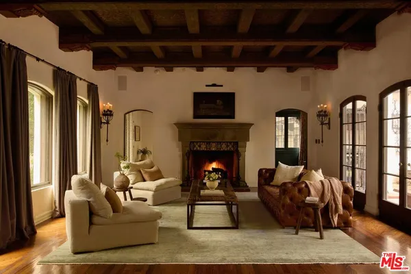 a living room with furniture and a book shelf