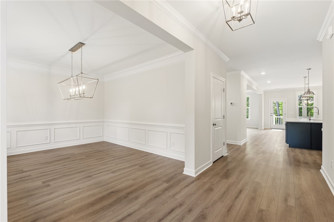 1108 Manse Jolly Road Anderson, SC 29621 - Photo 4 of 45 This bright and airy room features elegant wainscoting and durable flooring, creating an inviting atmosphere.