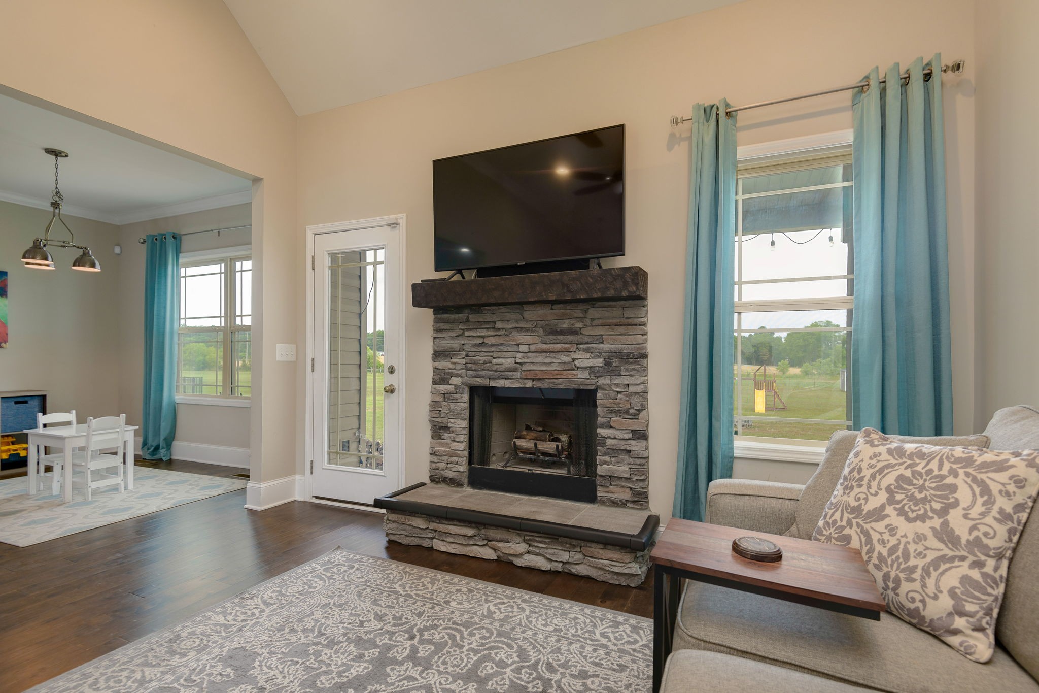 2251 Bluebird Road Lebanon, TN 37087 - Photo 15 of 62 a living room with furniture a flat screen tv and a fireplace