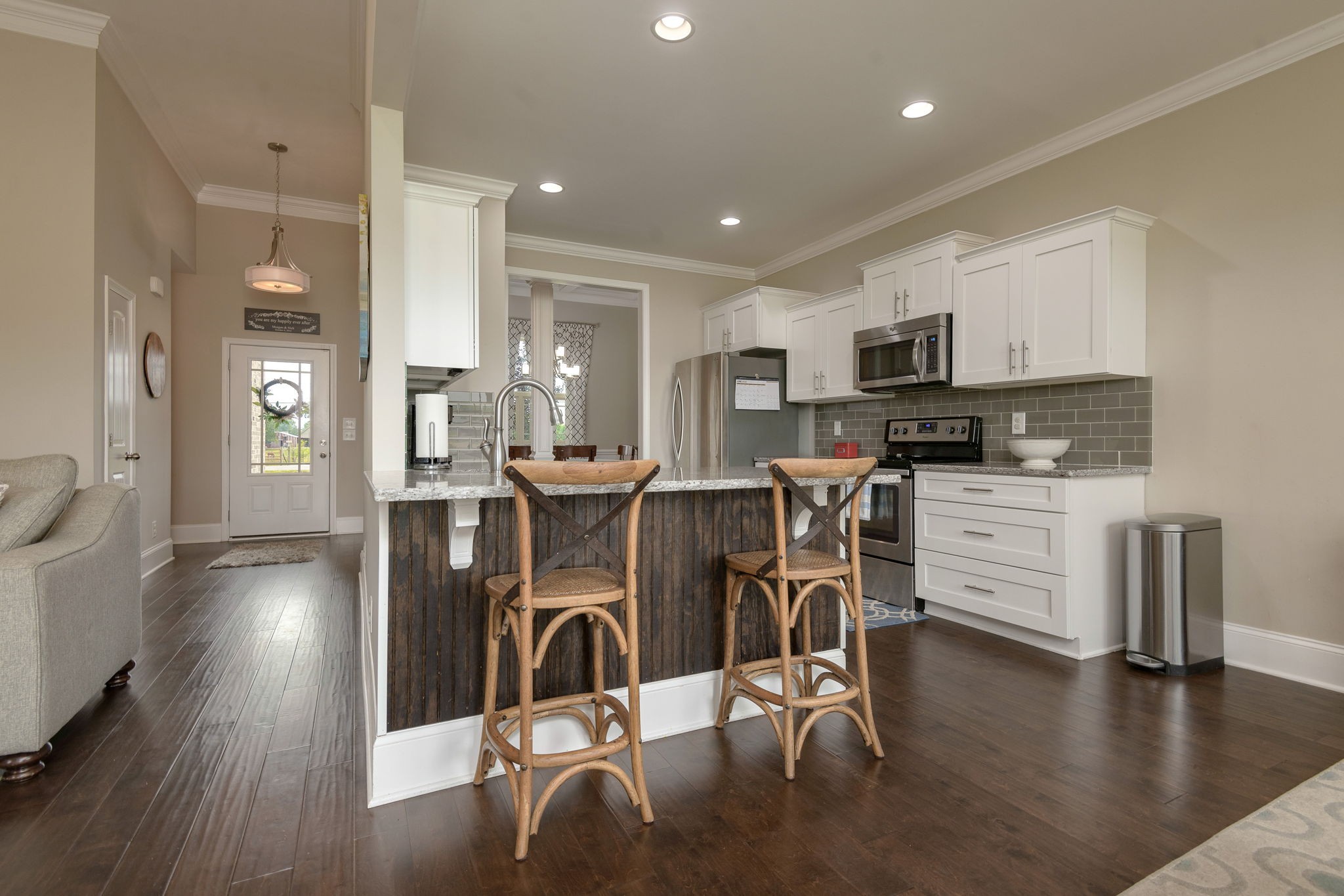 2251 Bluebird Road Lebanon, TN 37087 - Photo 29 of 62 a kitchen with stainless steel appliances a dining table chairs stove and white cabinets