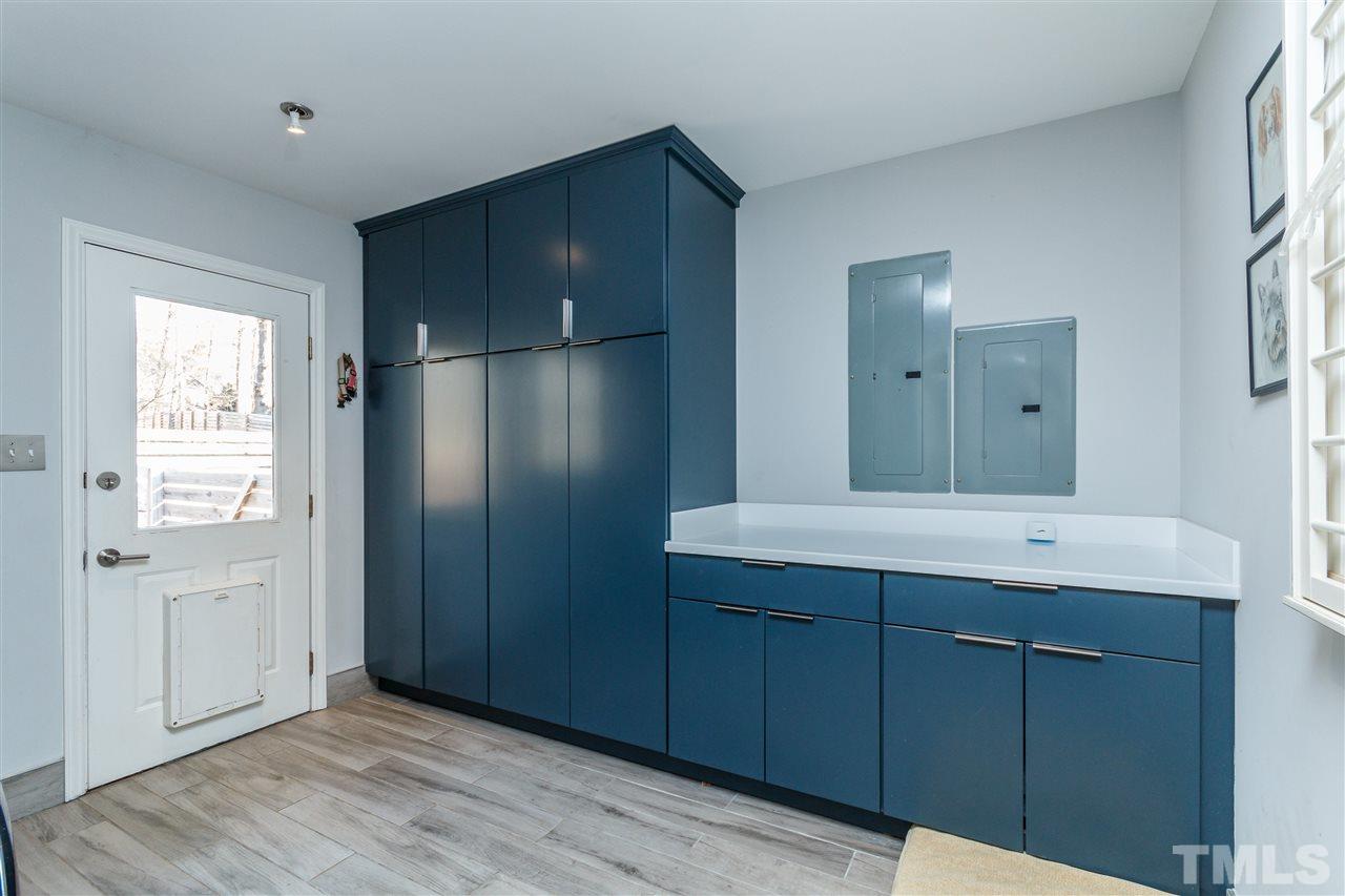 3412 1st Place Raleigh, NC 27613 - Photo 13 of 25 Blue slate Cabinets with extraordinary storage capasity. Corian solid surface countertops. New soft grey hardwood flooring.
