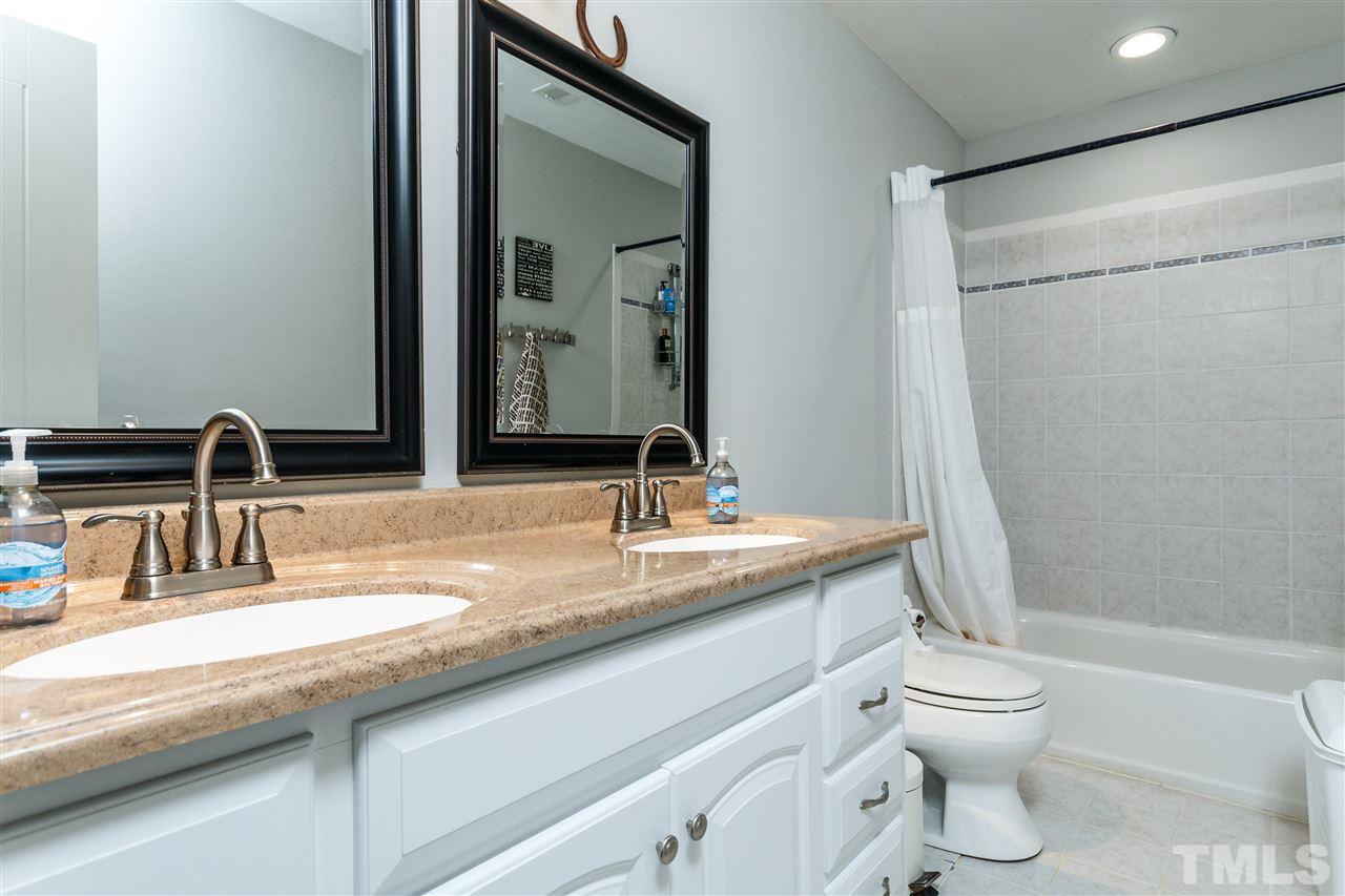 3412 1st Place Raleigh, NC 27613 - Photo 20 of 25 Granite counters with double vanity. Decorative tile.