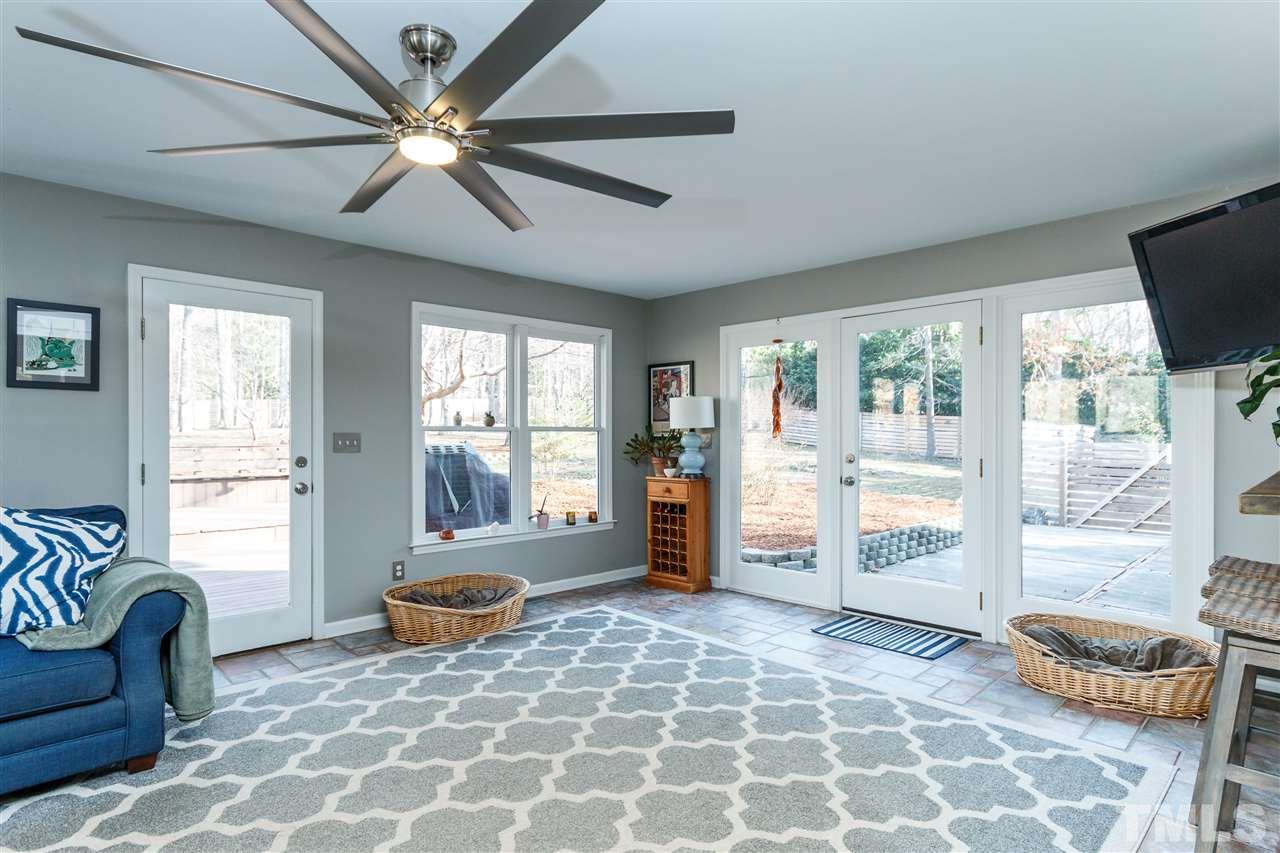 3412 1st Place Raleigh, NC 27613 - Photo 3 of 25 Cozy Sunroom with 2 exterior doors and lovely views of the outdoors. New decorative tile flooring and updated paint.