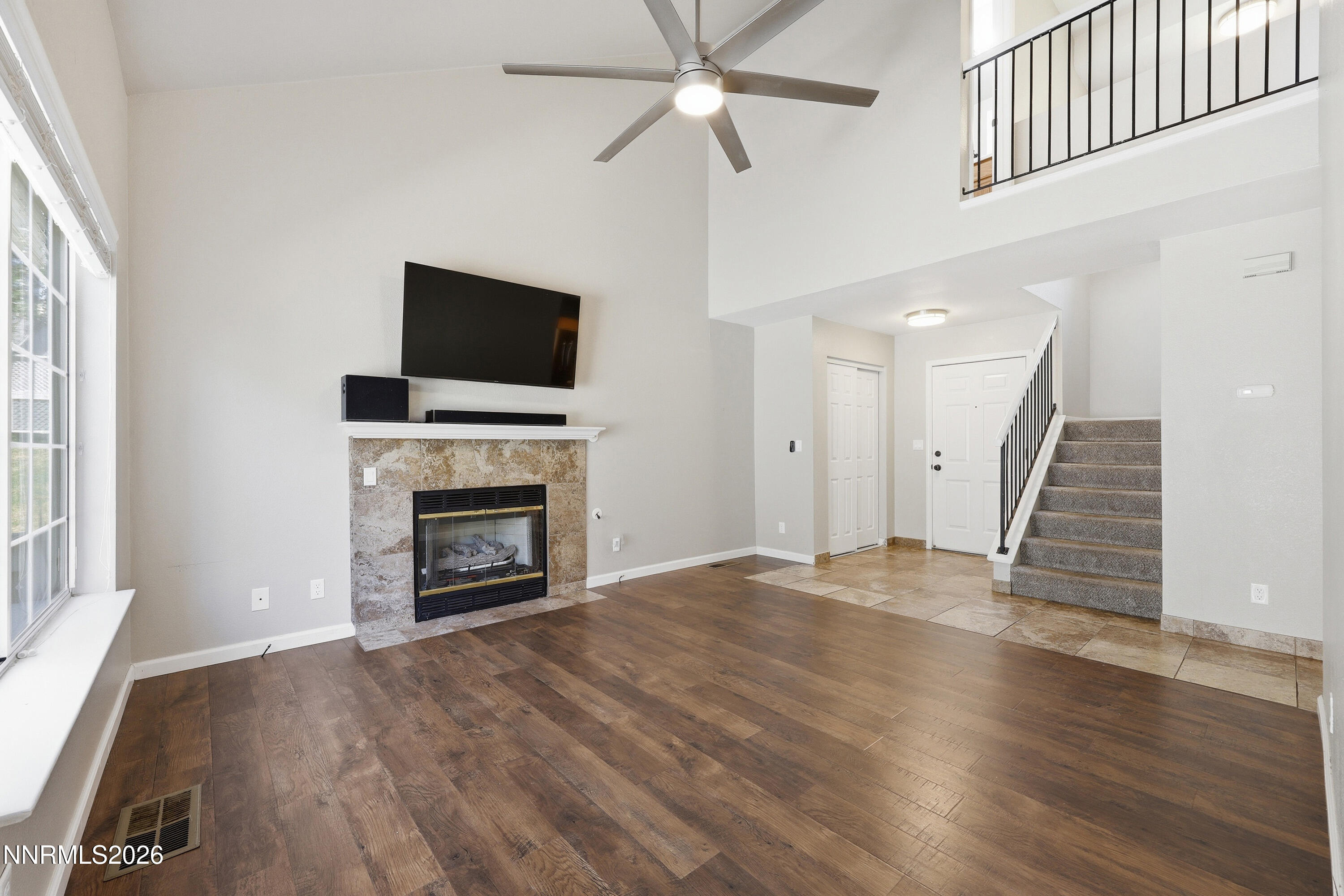 1899 Tuolumne Drive Reno, NV 89523 - Photo 7 of 44 an empty room with wooden floor fireplace and windows