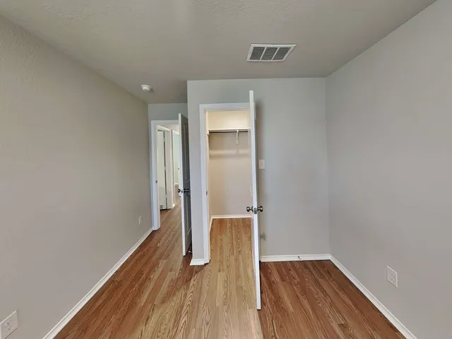 a view of a hallway with wooden floor