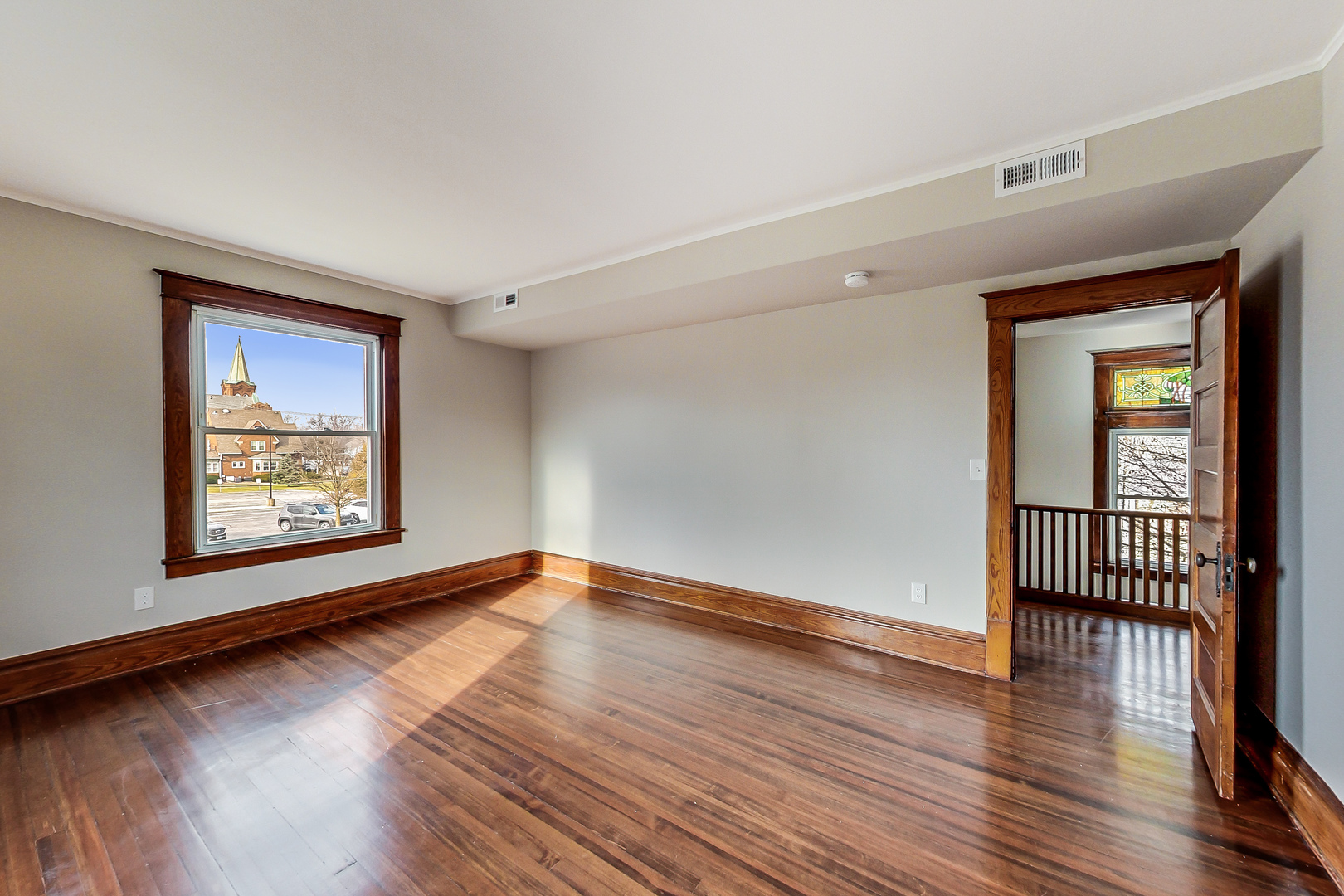 207 Center Road Frankfort, IL 60423 - Photo 21 of 41 a view of an empty room with wooden floor and a window