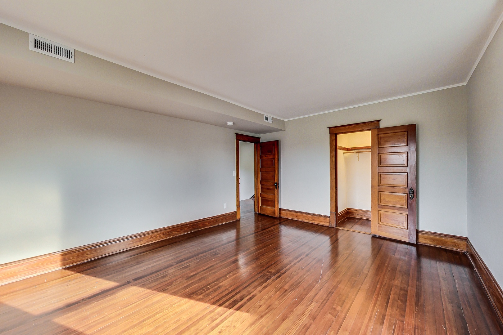 207 Center Road Frankfort, IL 60423 - Photo 22 of 41 a view of an empty room with window and wooden floor