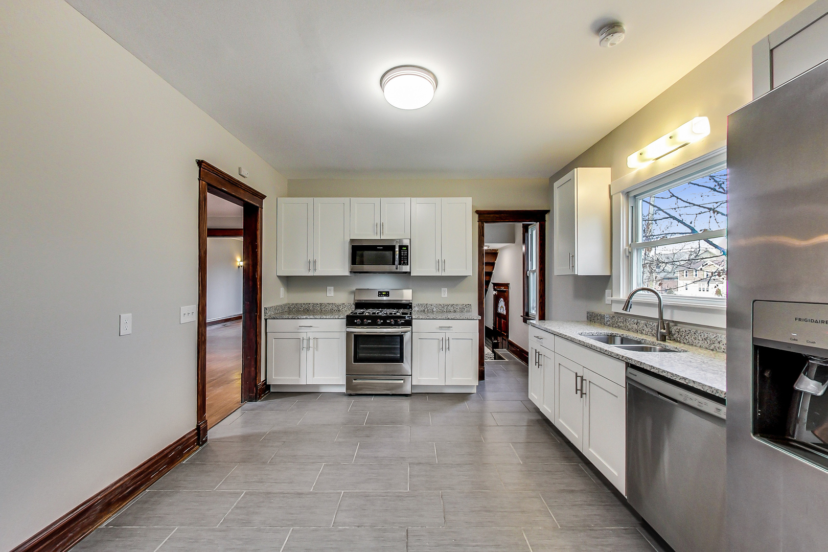 207 Center Road Frankfort, IL 60423 - Photo 8 of 41 a large kitchen with stainless steel appliances granite countertop a stove refrigerator and a sink