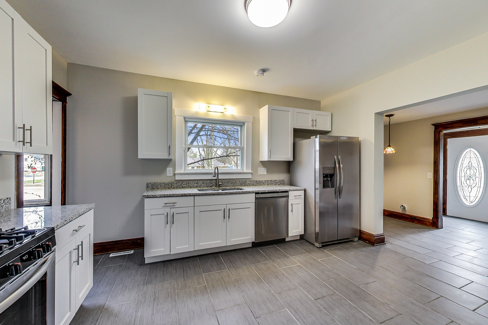 207 Center Road Frankfort, IL 60423 - Photo 9 of 41 a kitchen with stainless steel appliances a refrigerator a stove a sink and white cabinets