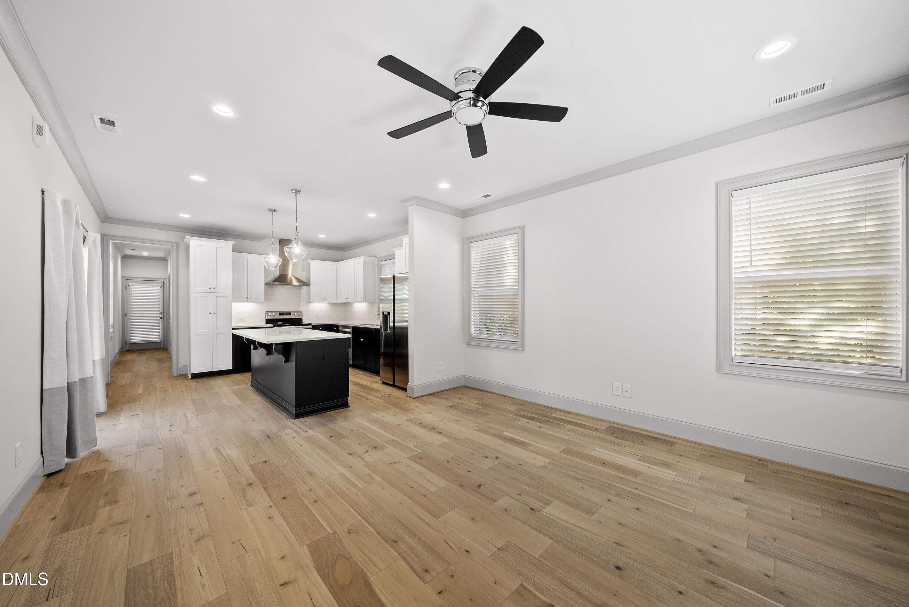 1501 Beauty Avenue Raleigh, NC 27610 - Photo 10 of 30 a view of a kitchen with kitchen island a sink wooden floor and black appliances