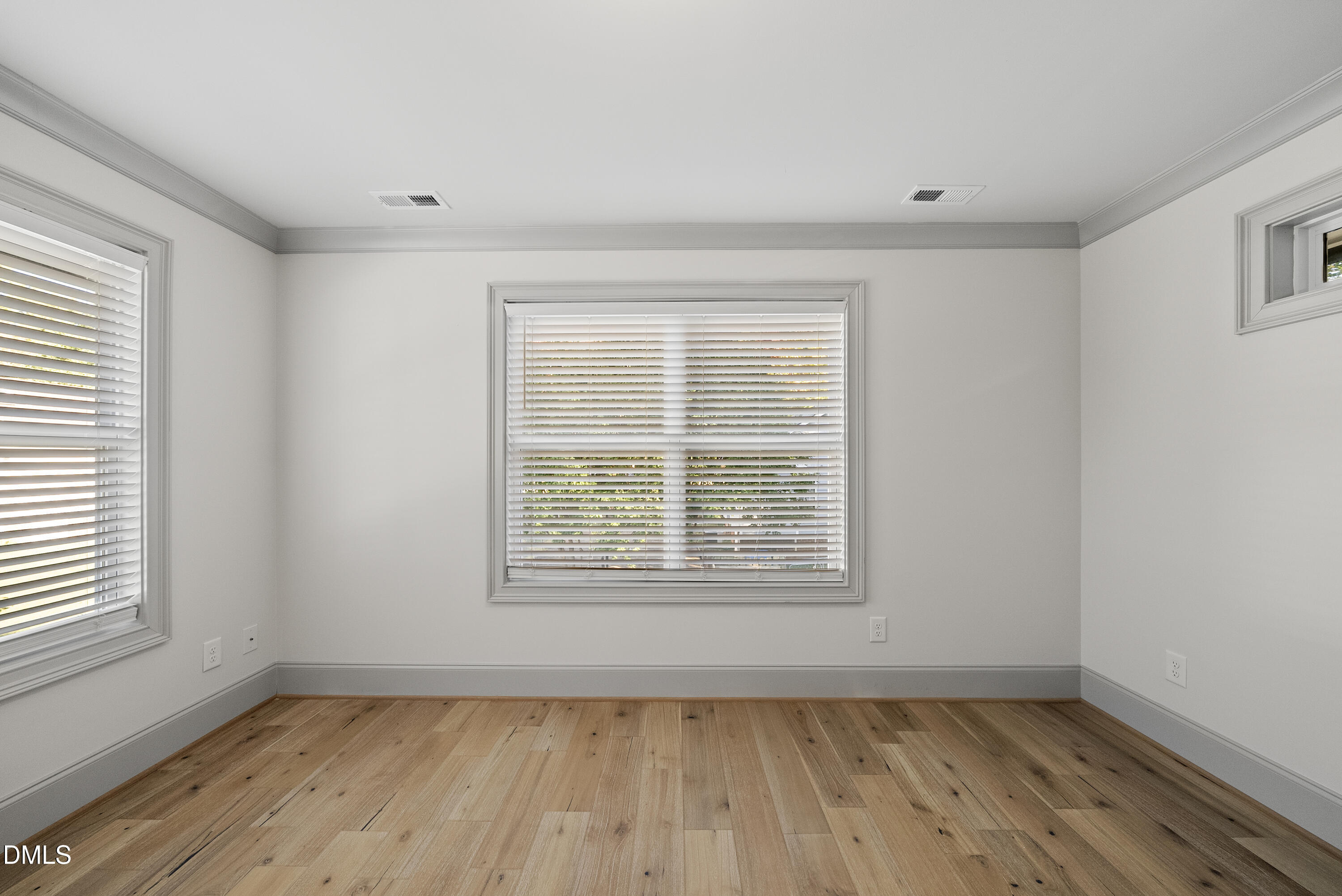 1501 Beauty Avenue Raleigh, NC 27610 - Photo 14 of 30 a view of an empty room with wooden floor and a window