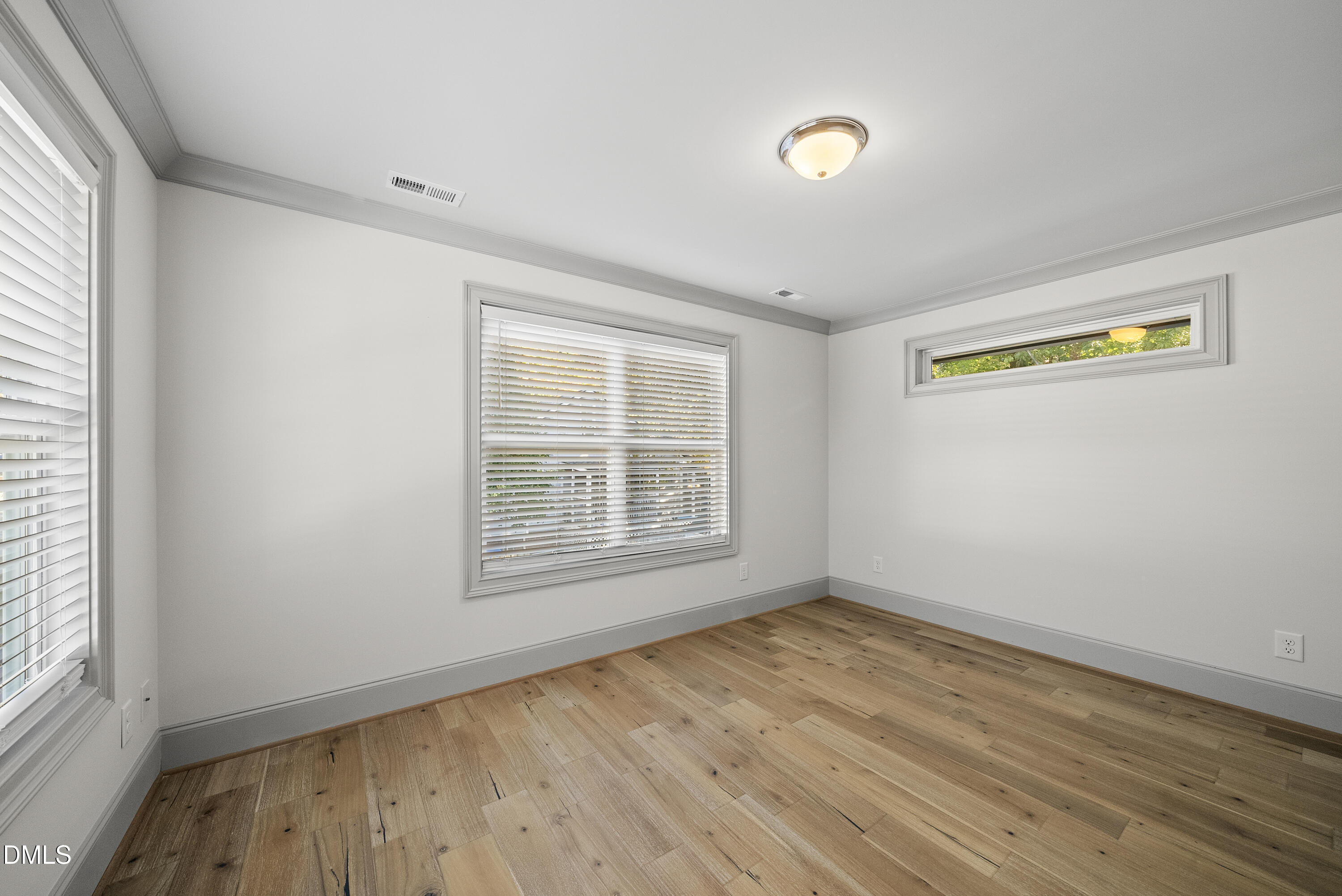 1501 Beauty Avenue Raleigh, NC 27610 - Photo 23 of 30 an empty room with wooden floor and windows