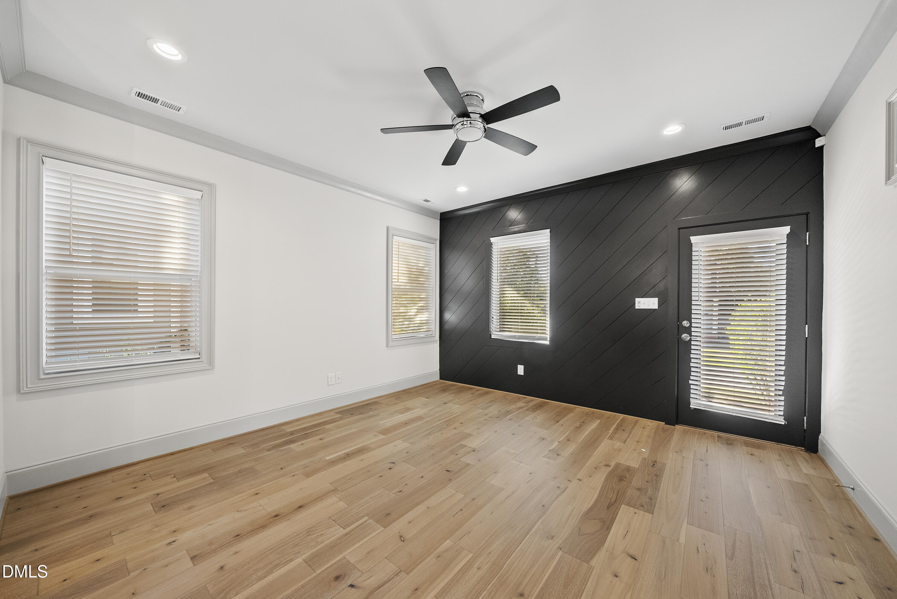 1501 Beauty Avenue Raleigh, NC 27610 - Photo 5 of 30 a view of an empty room with wooden floor and a window