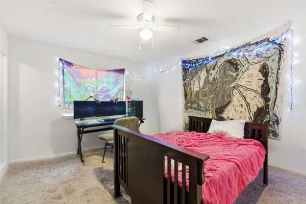 a bed room with a bed and a chair