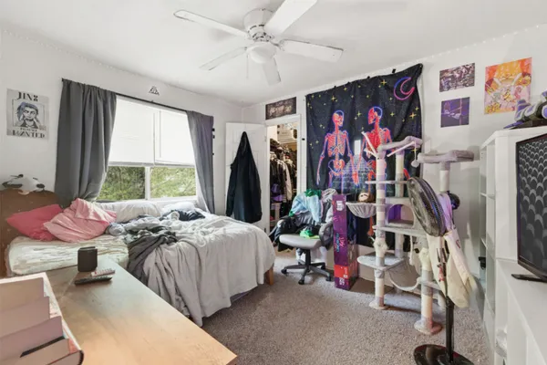 a bed room with a bed and a window