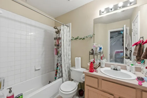 a bathroom with a sink toilet vanity and shower