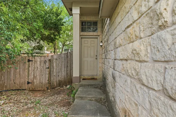 a view of a pathway gate with wooden fence