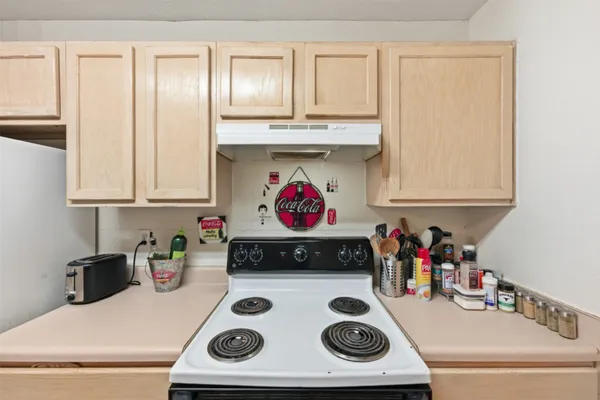 a kitchen with a stove a microwave and cabinets