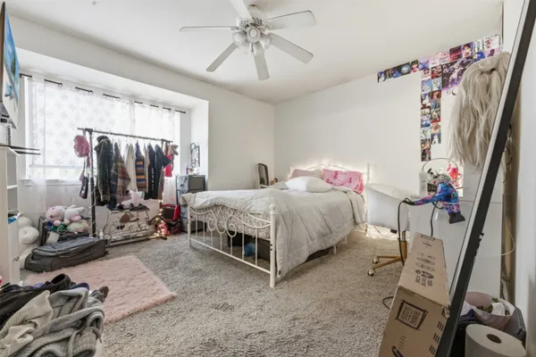 a bedroom with a bed closet and a flat tv screen