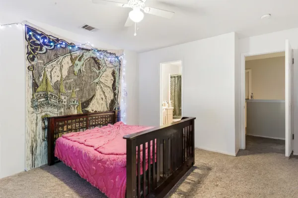 a bedroom with a bed and a window