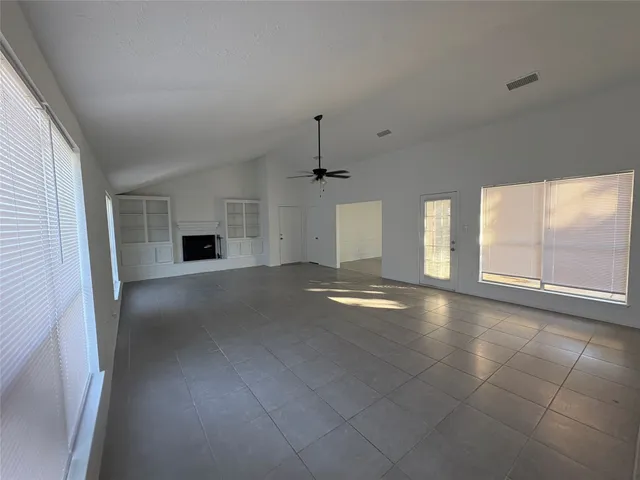 a view of empty room with floor to ceiling window