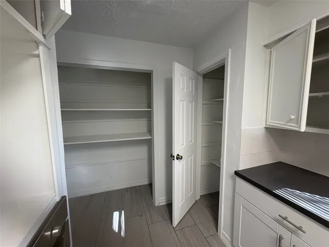 a kitchen with a refrigerator and cabinets