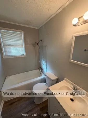 a bath tub sitting next to a white sink