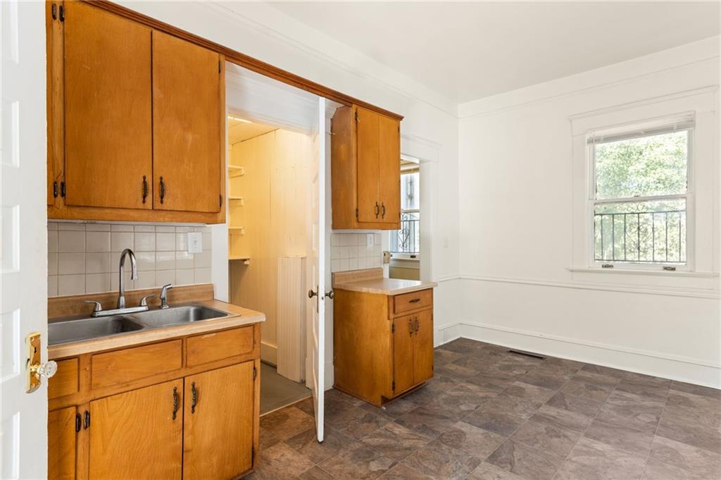 120 South Candler Street Decatur, GA 30030 - Photo 16 of 40 a kitchen with stainless steel appliances a refrigerator sink and cabinets