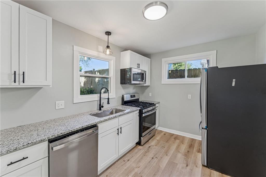 117 Owen Street McKees Rocks, PA 15136 - Photo 14 of 35 a kitchen with granite countertop a sink stainless steel appliances and cabinets