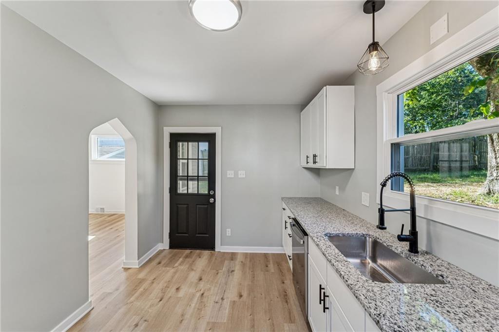 117 Owen Street McKees Rocks, PA 15136 - Photo 16 of 35 a kitchen with granite countertop a sink cabinets and wooden floor