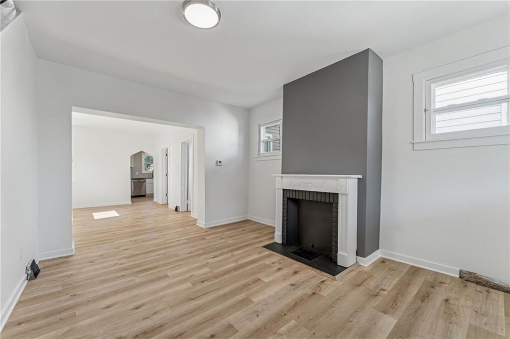 117 Owen Street McKees Rocks, PA 15136 - Photo 6 of 35 a view of a livingroom with wooden floor and a fireplace