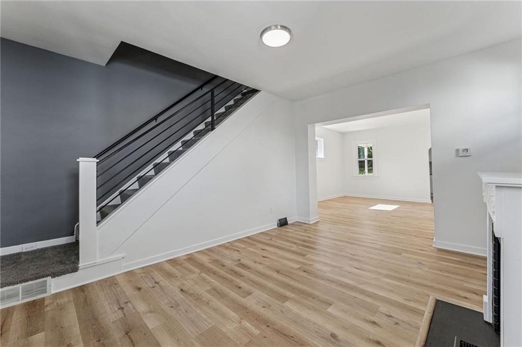 117 Owen Street McKees Rocks, PA 15136 - Photo 7 of 35 a view of an empty room with wooden floor and stairs