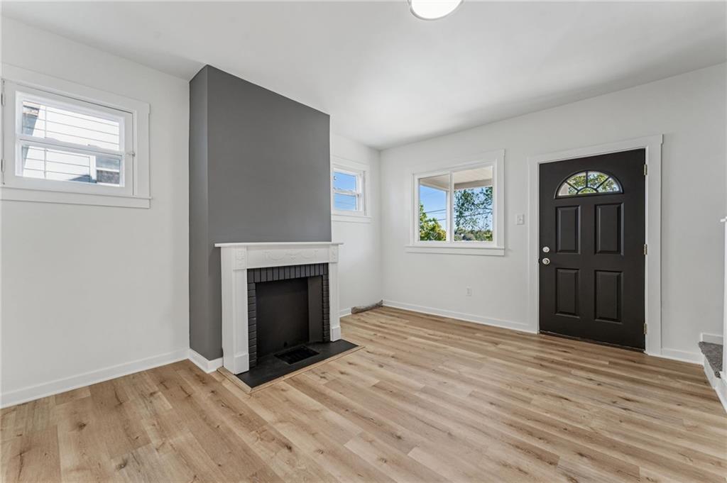 117 Owen Street McKees Rocks, PA 15136 - Photo 8 of 35 an empty room with windows and a fireplace