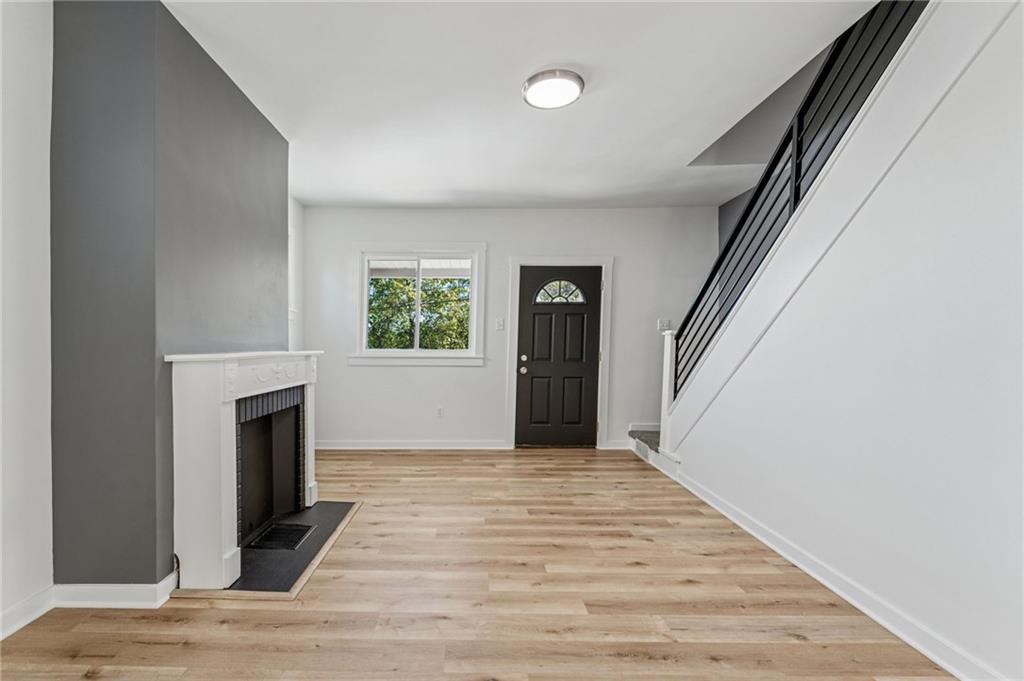 117 Owen Street McKees Rocks, PA 15136 - Photo 9 of 35 a view of a livingroom with wooden floor and a fireplace