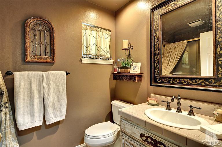 10612 Chippenham Road Camarillo, CA 93012 - Photo 12 of 16 a bathroom with a granite countertop sink toilet and mirror