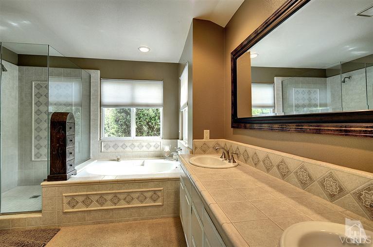 10612 Chippenham Road Camarillo, CA 93012 - Photo 14 of 16 a spacious bathroom with a tub sink and mirror