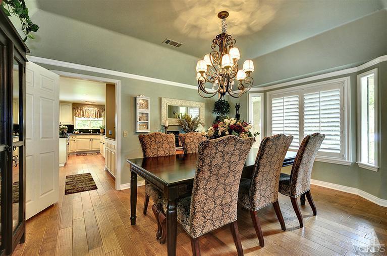 10612 Chippenham Road Camarillo, CA 93012 - Photo 3 of 16 a view of a dining room with furniture a chandelier and wooden floor