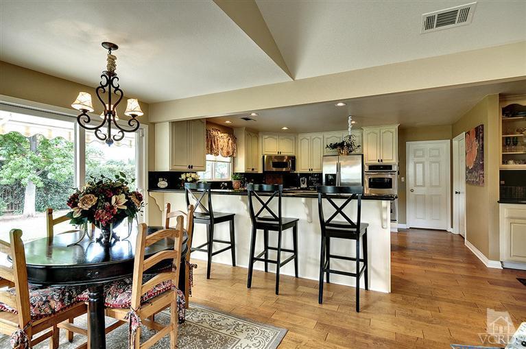 10612 Chippenham Road Camarillo, CA 93012 - Photo 8 of 16 a dining room with furniture a chandelier and kitchen view
