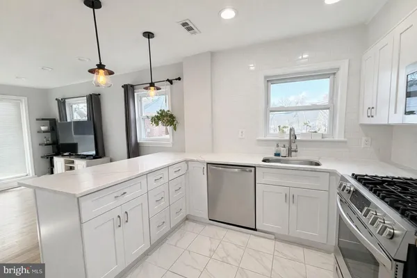 a kitchen with a sink stove and cabinets