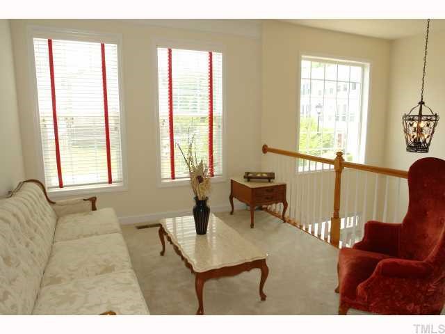 5326 Echo Ridge Road Raleigh, NC 27612 - Photo 3 of 12 a living room with furniture and floor to ceiling windows