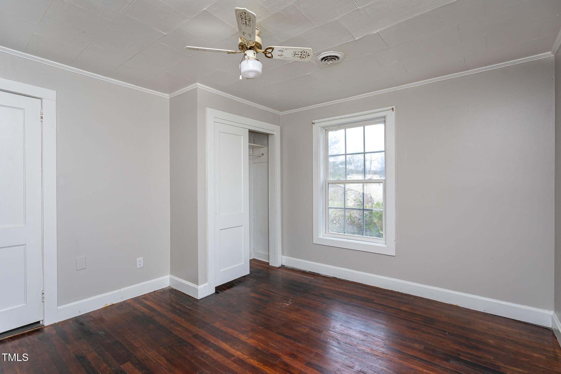 1239 Brogden Road Smithfield, NC 27577 - Photo 11 of 14 an empty room with wooden floor ceiling fan and windows