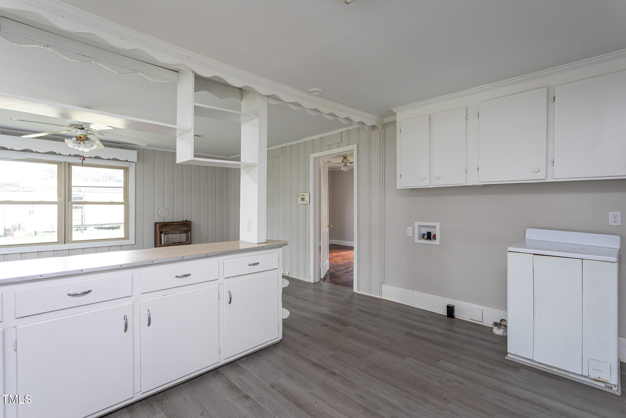 1239 Brogden Road Smithfield, NC 27577 - Photo 6 of 14 a kitchen with white cabinets and wooden floor