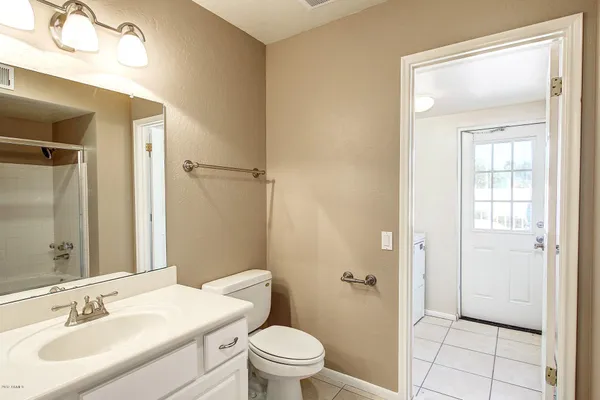 a bathroom with a sink vanity and a mirror