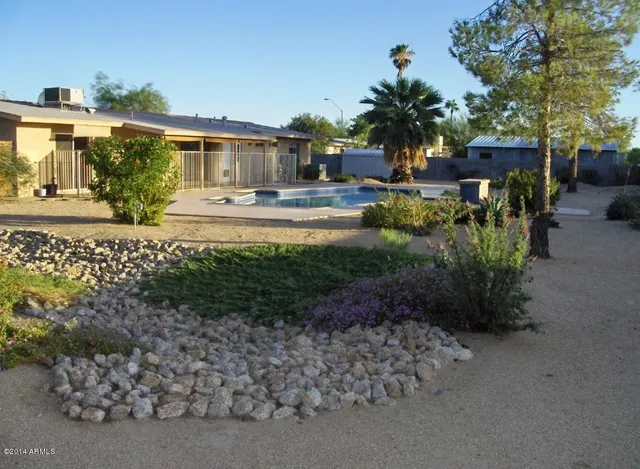 a view of a house with a backyard