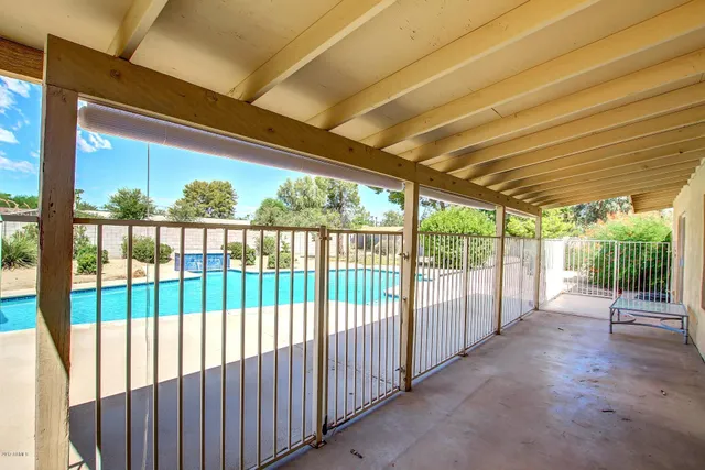 a view of a backyard with table and chairs