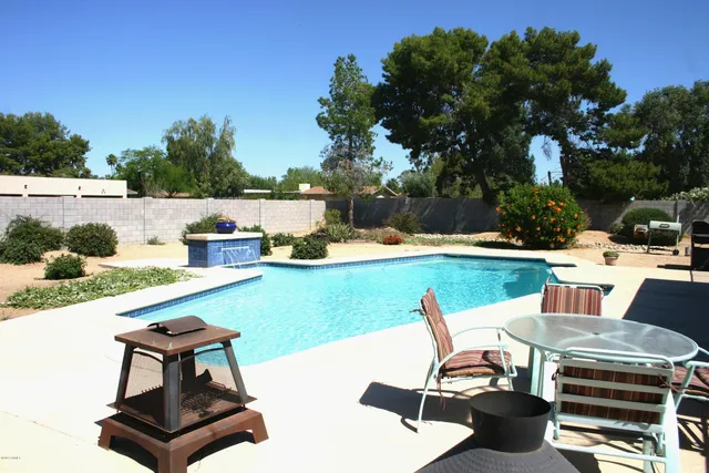 a road view with outdoor seating and trees